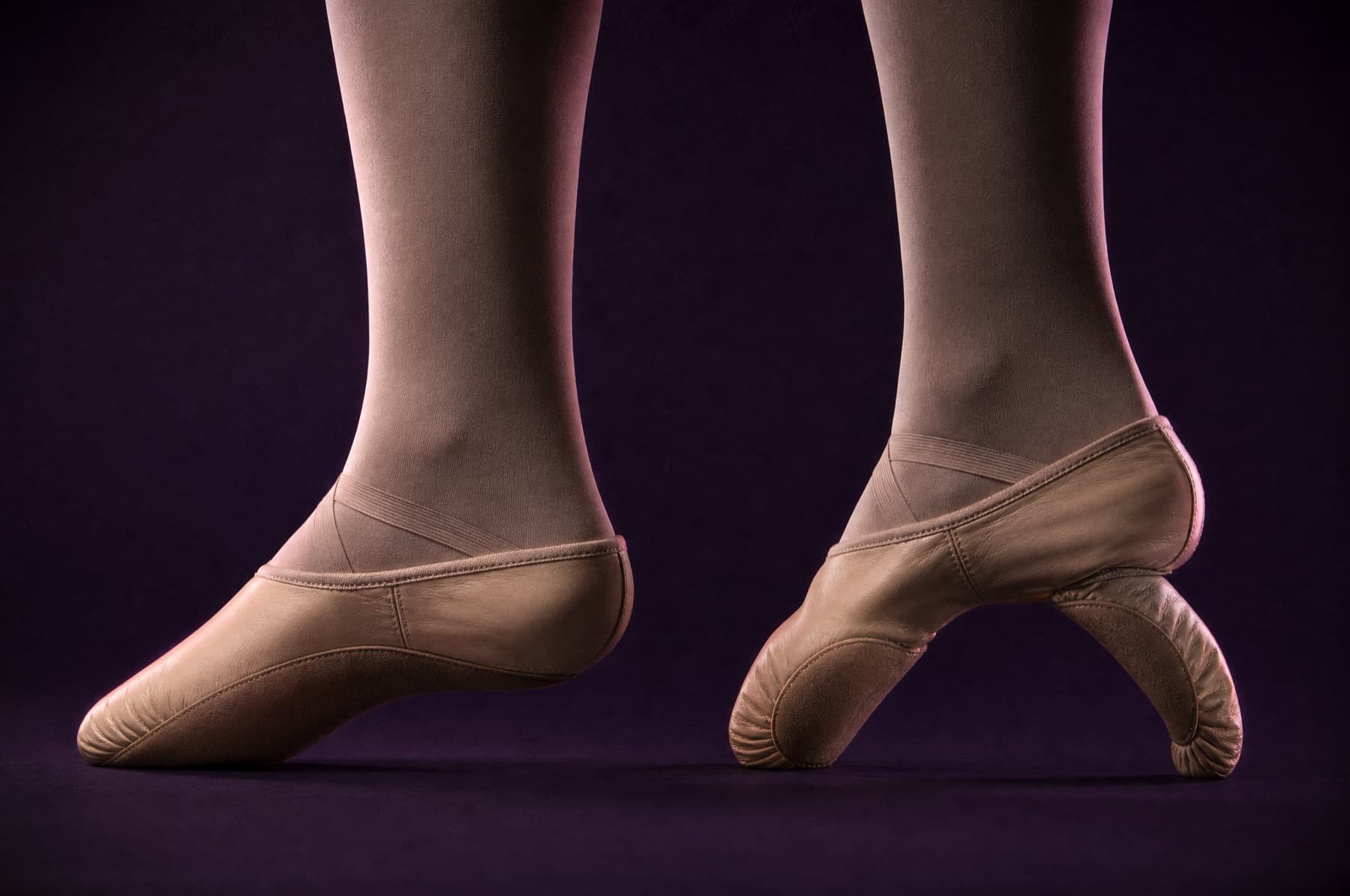 A full-sole and a split-sole slipper bent side by side, the split sole forming a much deeper arc